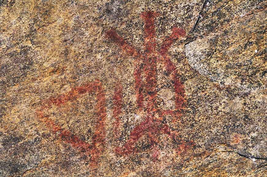 Cave painting depicting a triangle and a turtle.