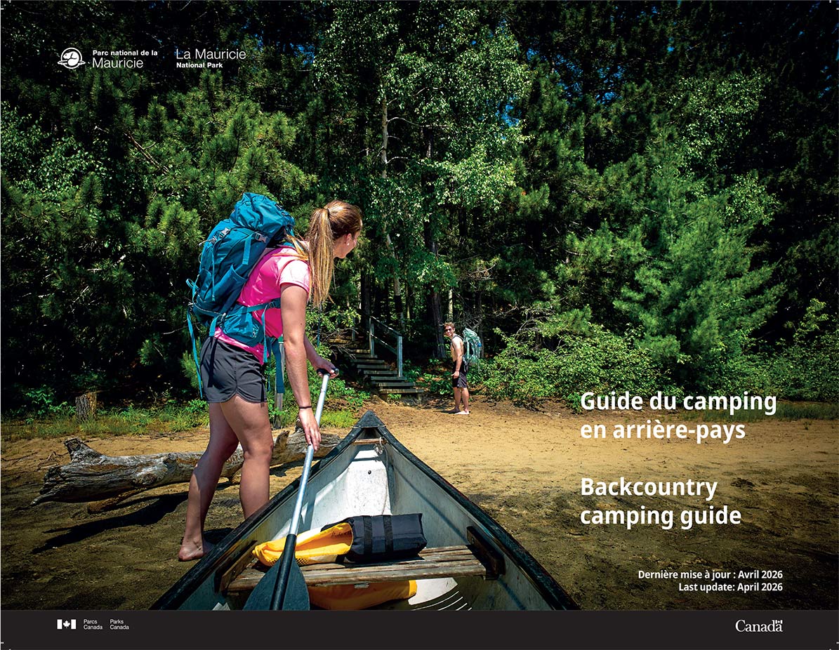 2026 backcountry camping guide cover - a young canoer hauls her canoe on a beach.