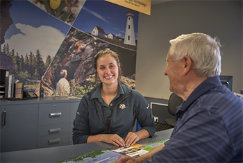 A Parks Canada employee  welcoming a visitor to Mingan Archipelago