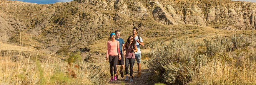 A group of young adults out hiking on the 70 Mile Butte Trail at West Block, in Grasslands National Park.