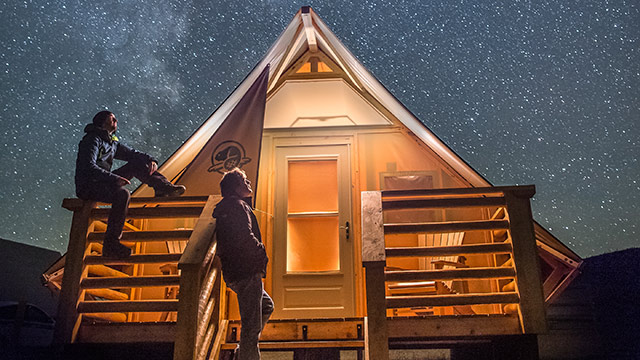 Parks Canada oTENTik below the Milky Way at night in the Dark Sky Preserve, in Grasslands National Park.