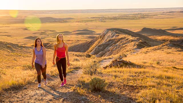 Young adults out hiking on the 70 Mile Butte Trail at West Block, in Grasslands National Park.