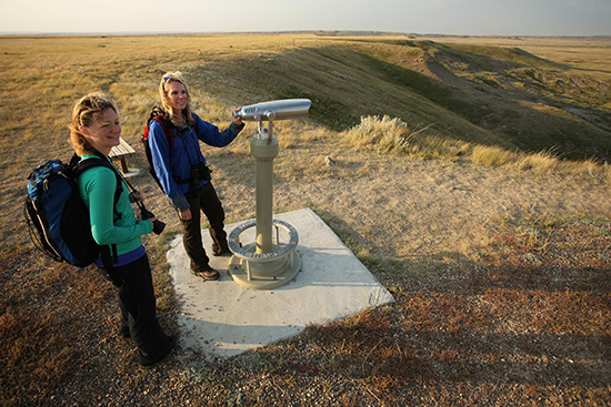 Two women enjoy the view from the telescope lookout along the Top Dog Trail.