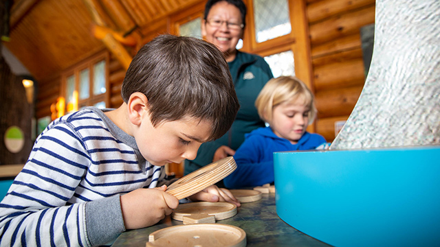 Visitors explore the Parks Canada Nature Centre in Waskesiu in Prince Albert National Park