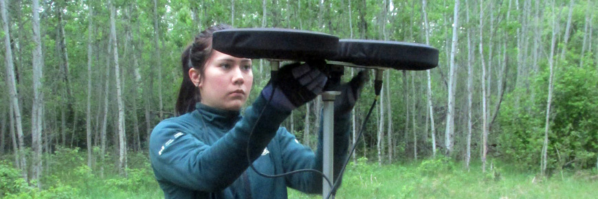A Resource Conservation Technition adjusts a large sterio microphone.