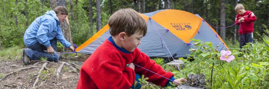 Family setting up a tent