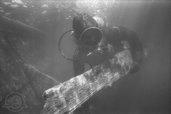 Diver Bob Masse bringing up a piece of wood from the Machault