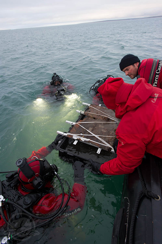 Underwater archaeologists recovering artifacts