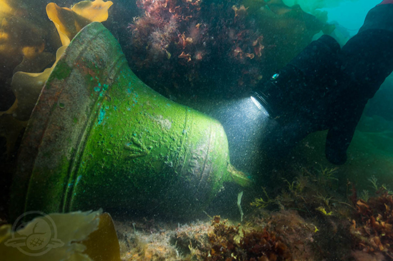 A bronze bell lying on the ship