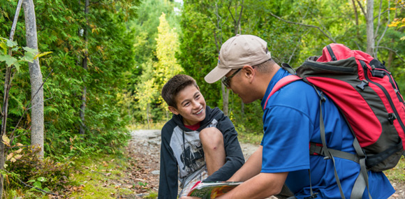 Two visitors observing nature on a trail in Rouge National Urban Park