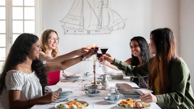 Four adults having dinner at Fortress of Louisbourg.