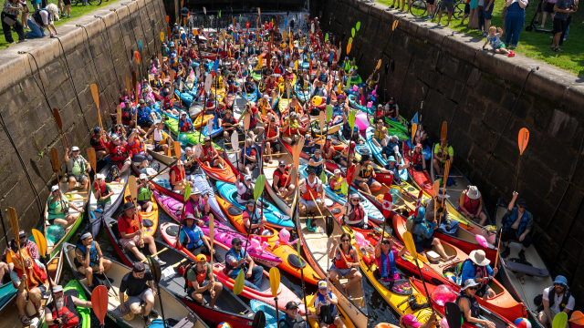 Numerous canoeists and kayakers crowded into a lock on the Rideau Canal.