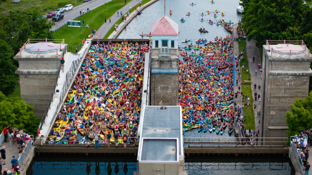 Numerous canoeists and kayakers crowded into a lock on the Rideau Canal.