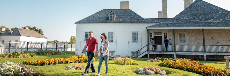 Visitors explore colorful flower gardens outside the Big House. 