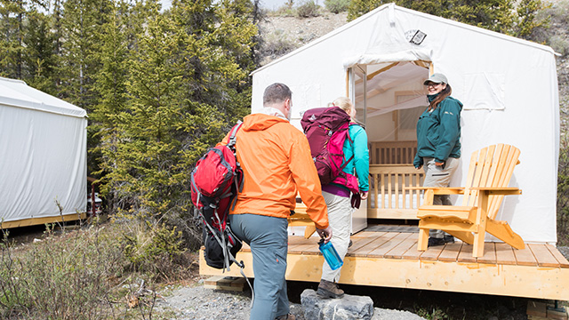 Two visitors enter their McPherson tent at Ivvavik base camp.