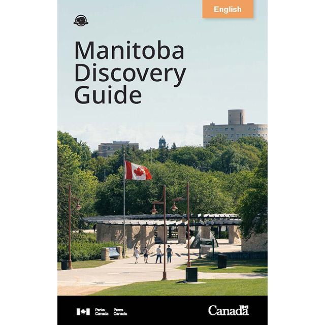 The cover of the Parks Canada Manitoba Discovery Guide featuring an image of four people walking along a path toward the Orientation Circle at The Forks National Historic Site.