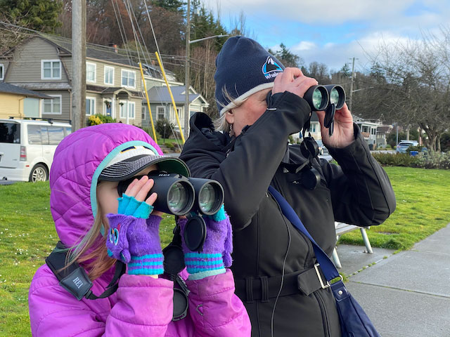Two people using binoculars