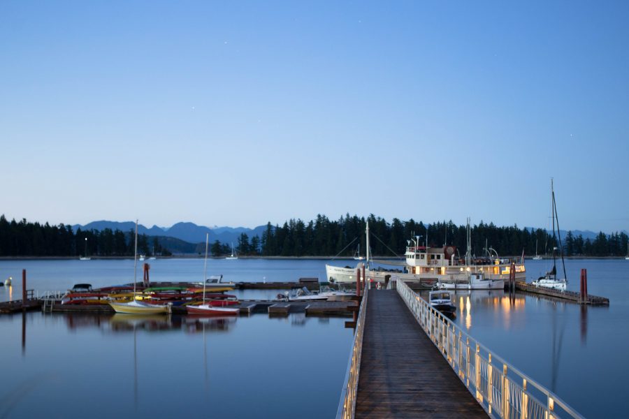 Looking down a floating dock with boats moored on the sides at Taku Resort and Marina