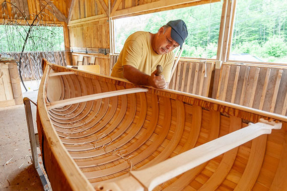 Todd Labrador working on a birch bark canoe.
