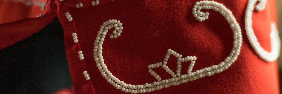 Mi'kmaq beadwork adorning the cuff of a wool coat.