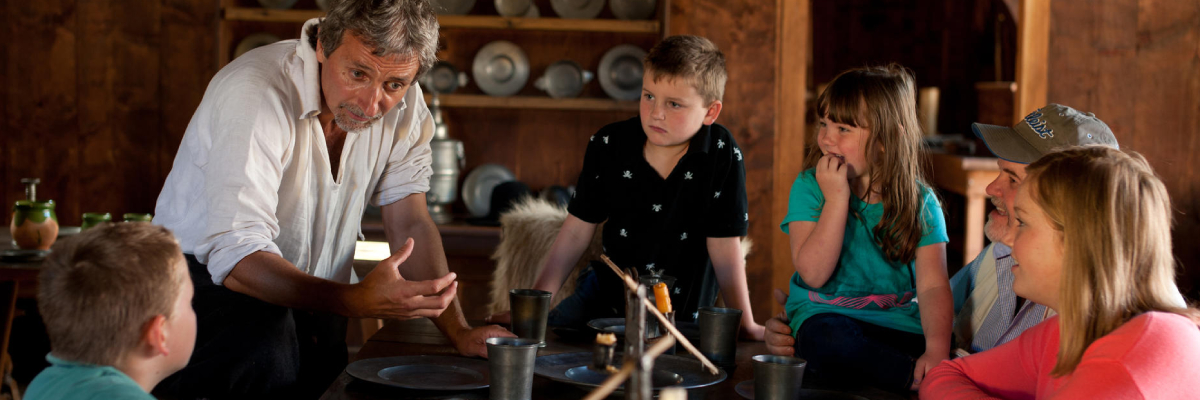 An interpreter speaks with young visitors