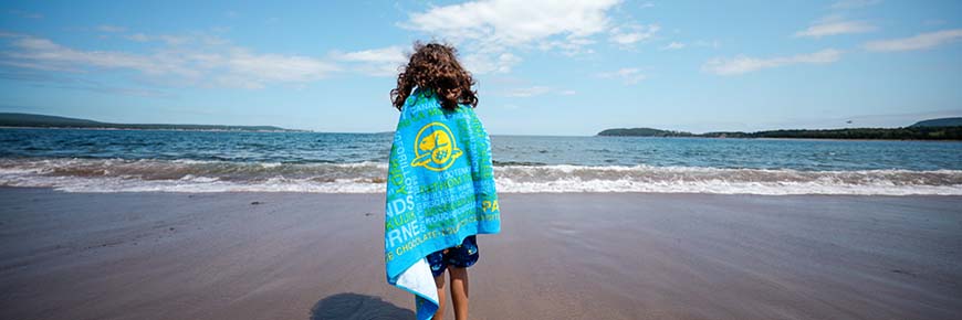 A young girl wrapped in a towel at North Bay Beach.