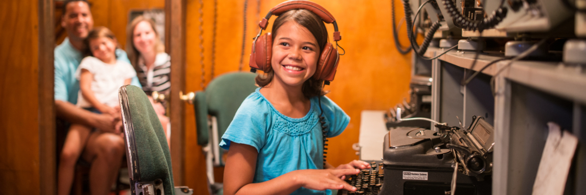 A young visitor and her family on Radio 1 at HMCS Haida National Historic Site