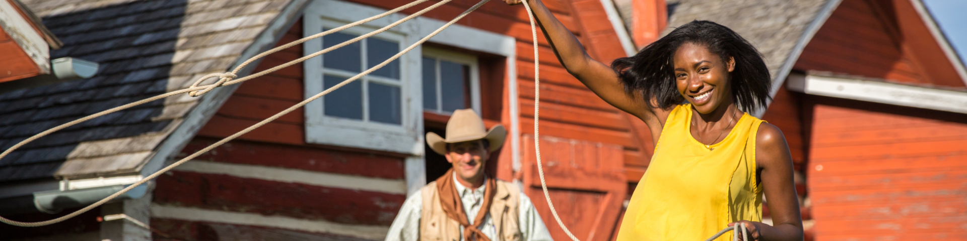 A young woman tries roping a replica steer at Bar U Ranch National Historic Site.