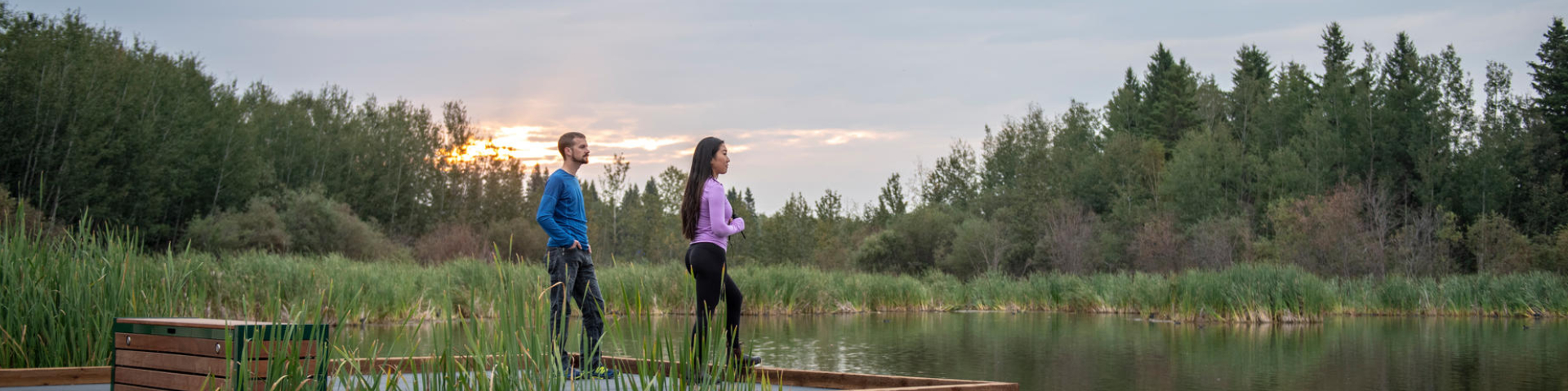 Two visitors on the Living Waters Boardwalk in Elk Island National Park.