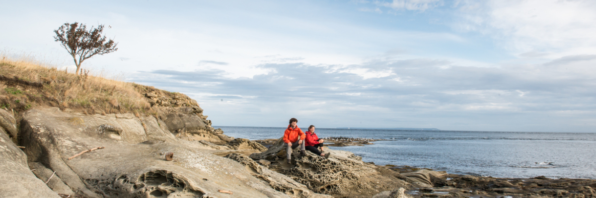 A couple at East Point, on Saturna Island, enjoy the panoramic ocean views