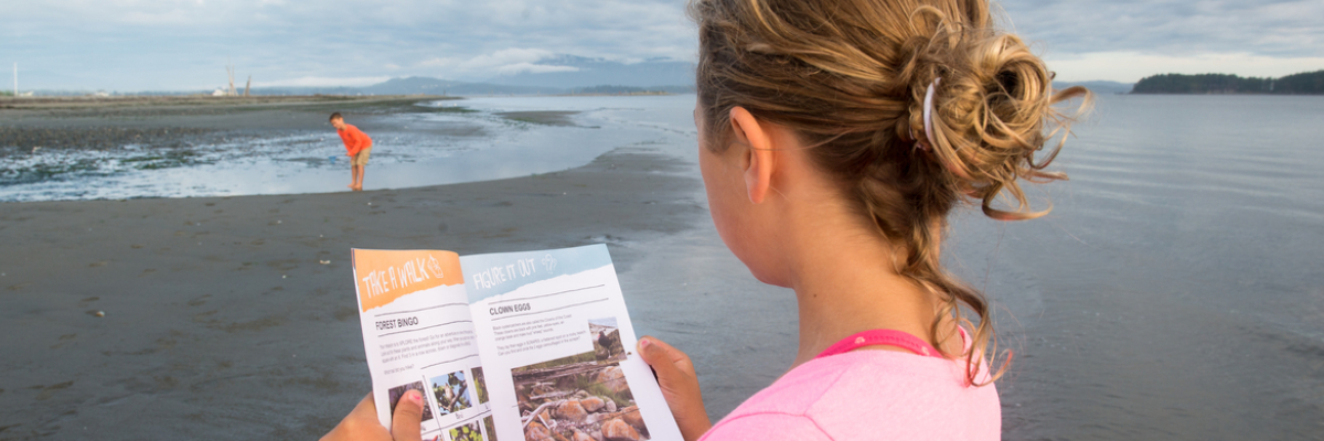 On Sidney Spit, two kids explore shallow water lapping at the shore