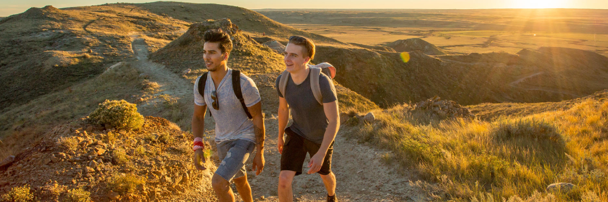 Two young adults out hiking on the 70 Mile Butte Trail in Grasslands National Park.