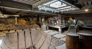 Visitors observe the icebox located at the entrance to the site