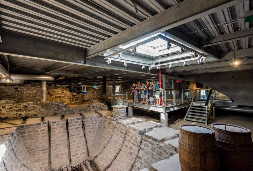 Visitors observe the icebox located at the entrance to the site