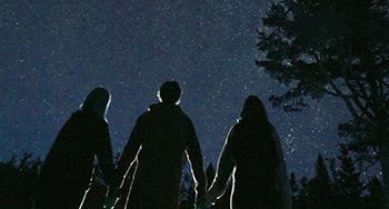 Group of people looking up at the stars